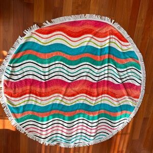 Chicos Wavy Striped Round Beach Towel with white fringe.